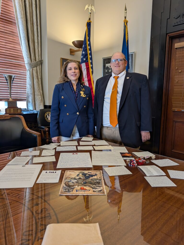 Representative Mike Bayham, chairman of the Louisiana American 250 Commission, and Representative Aimee Freeman pose with items Louisiana submitted for inclusion in the America 250 Time Capsule being buried at Independence National Historical Park in Philadelphia on July 4, to be opened in 2276. (Image credit: Louisiana America 250 Commission)